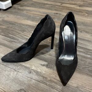 Stuart Weitzman suede pumps featuring a pointed toe and scalloped edge design.
